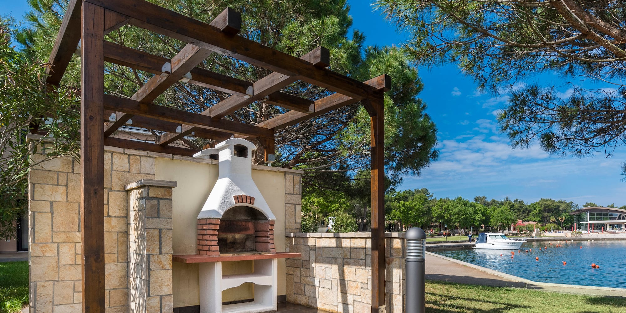a outdoor fireplace with a wood pergola over it