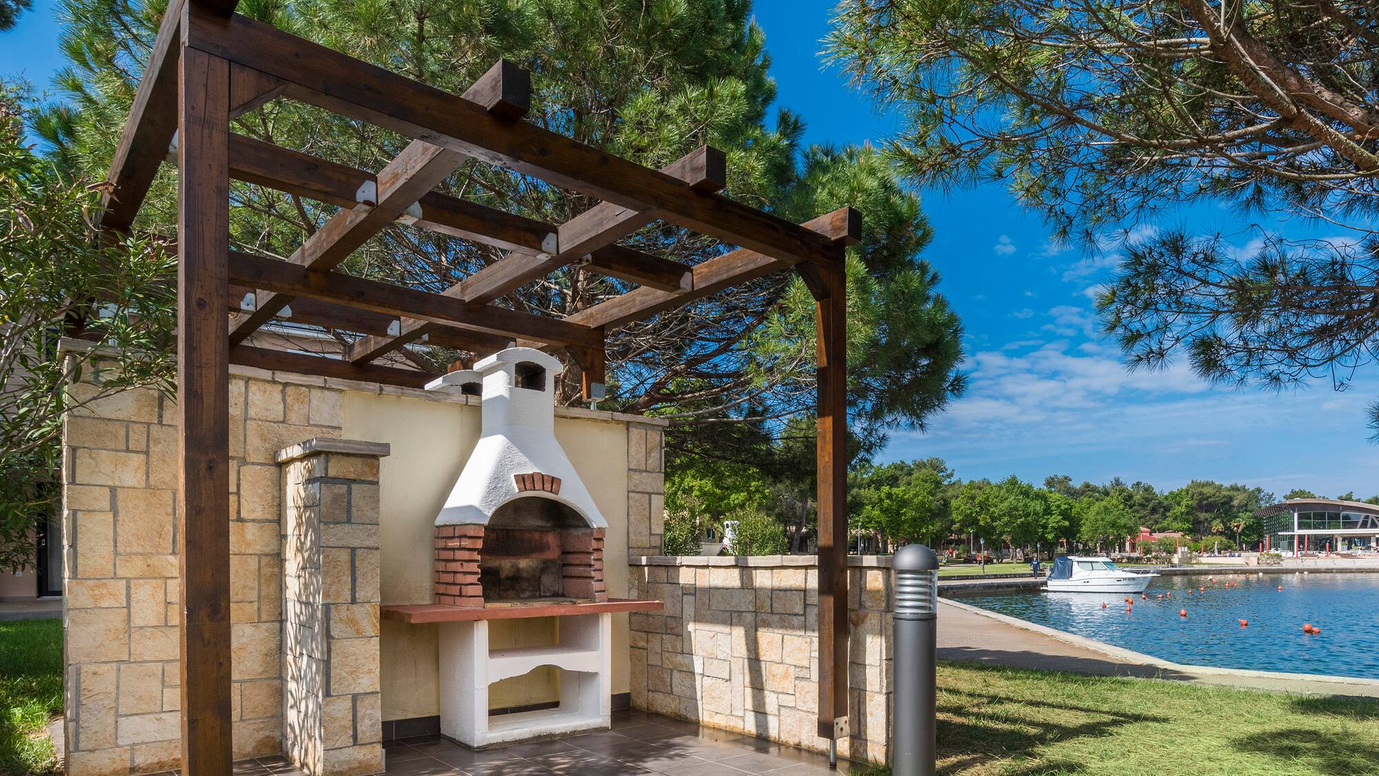 a outdoor fireplace with a wood pergola over it
