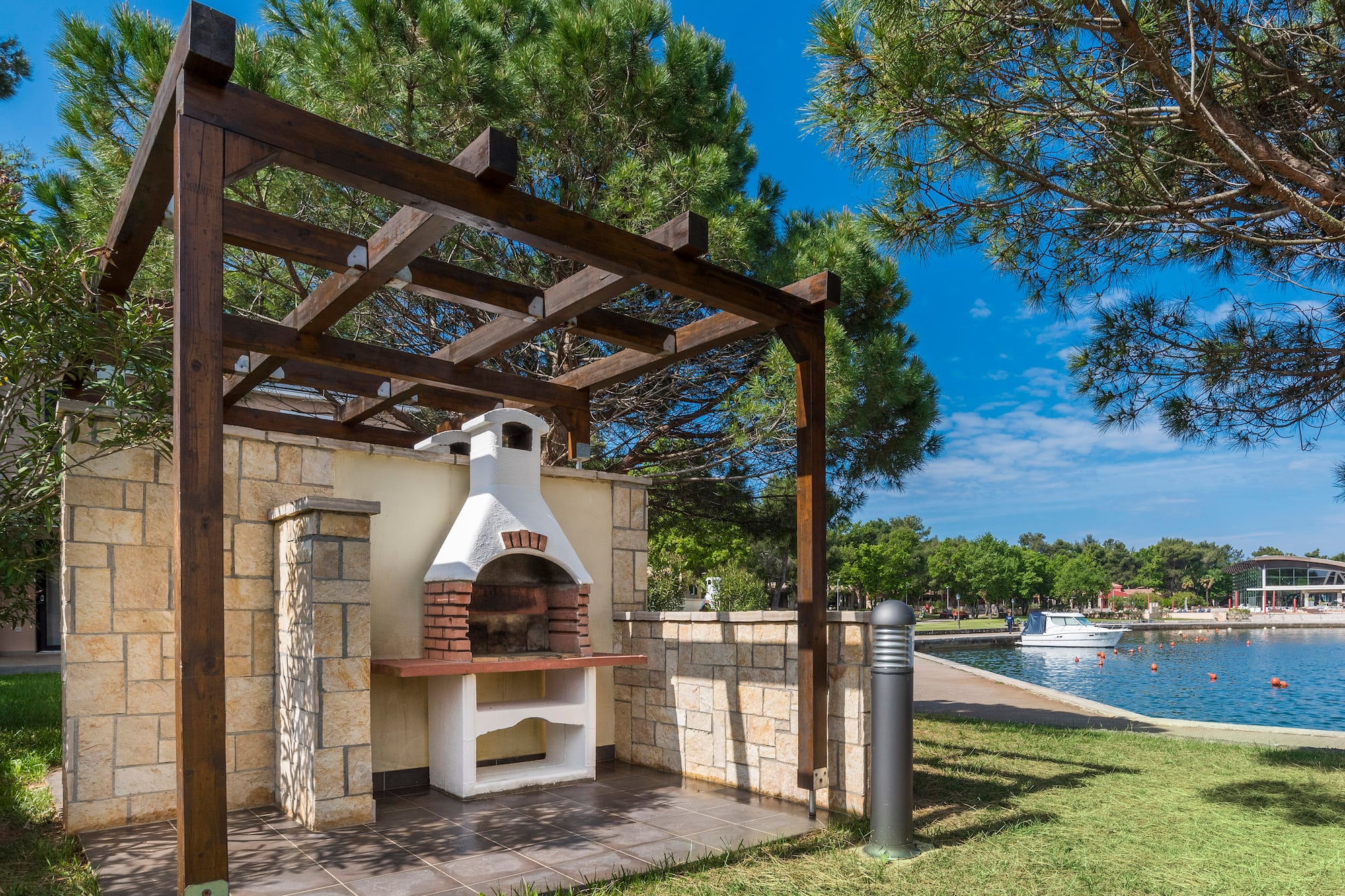 a outdoor fireplace with a wood pergola over it