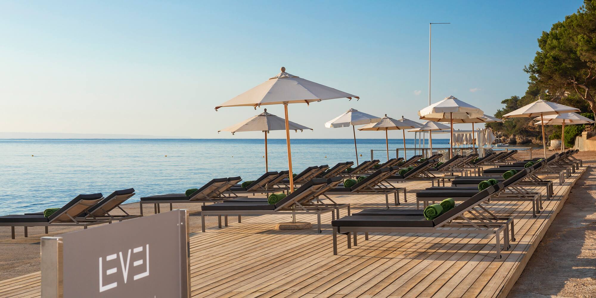 a beach with chairs and umbrellas