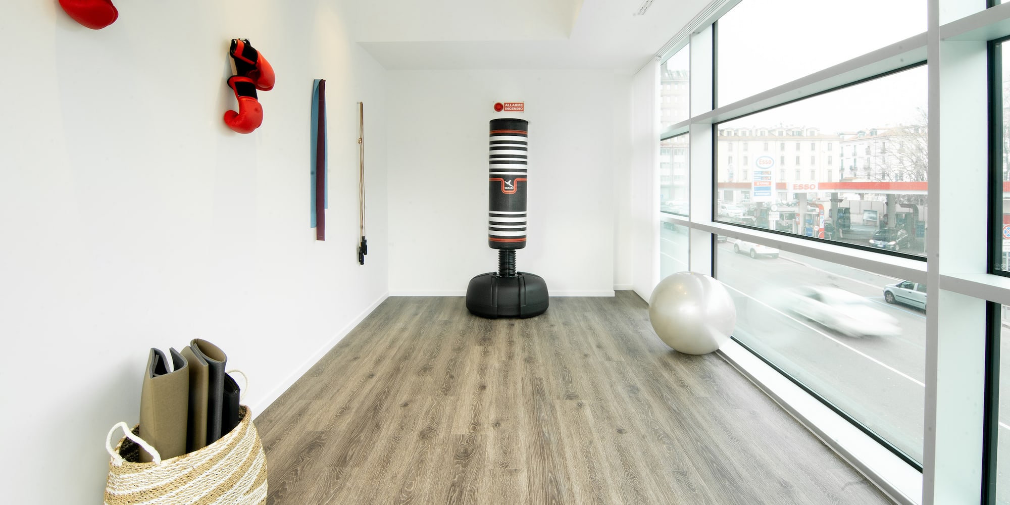 a room with a large window and a large bag of yoga mats