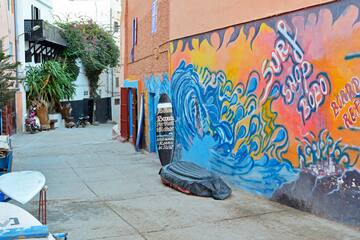 a street featuring a mural on the side of a building