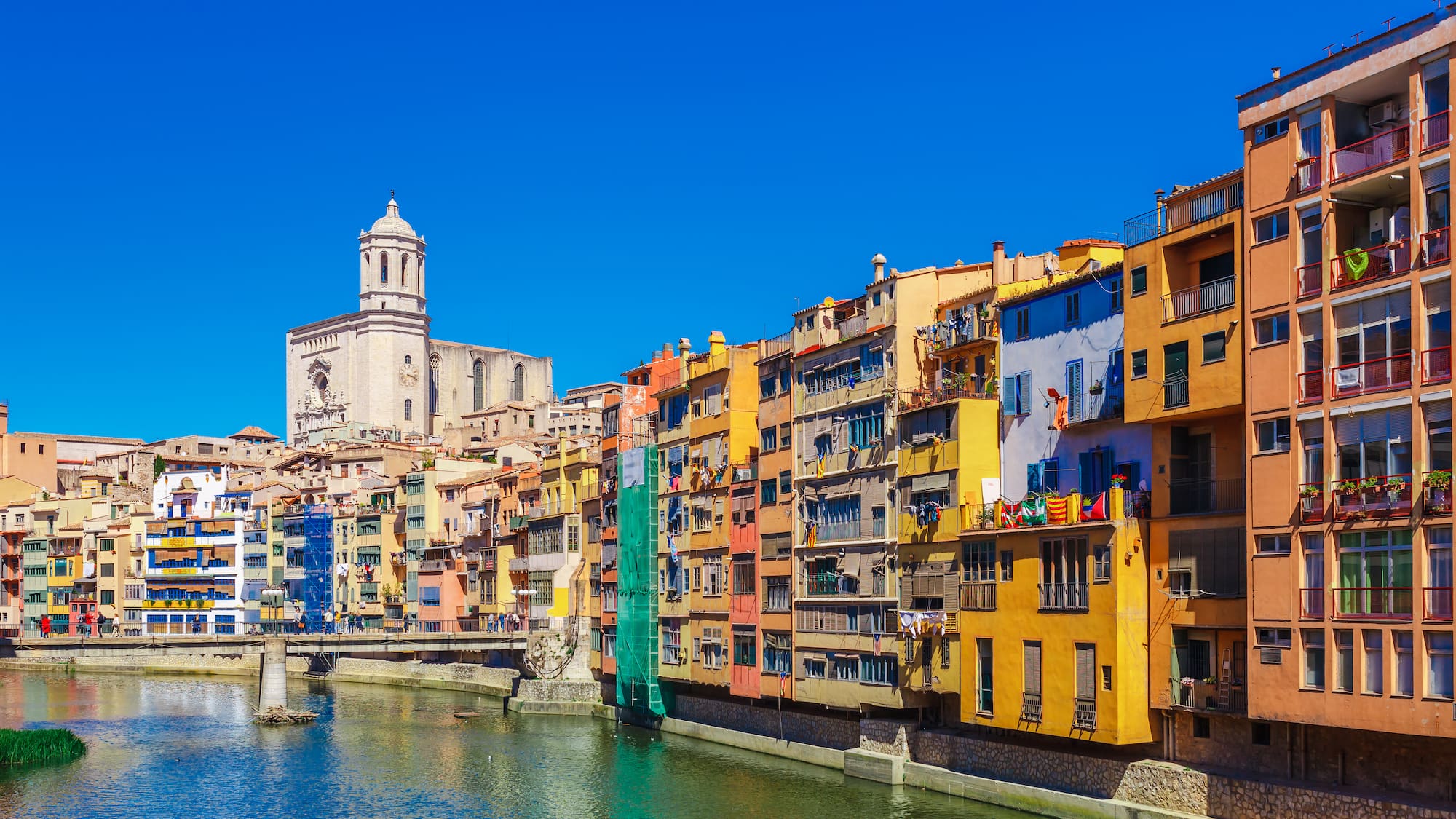 a river with buildings and a tower