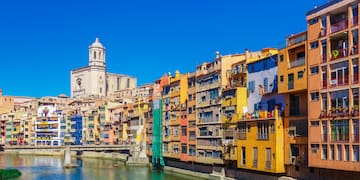 a river with buildings and a tower