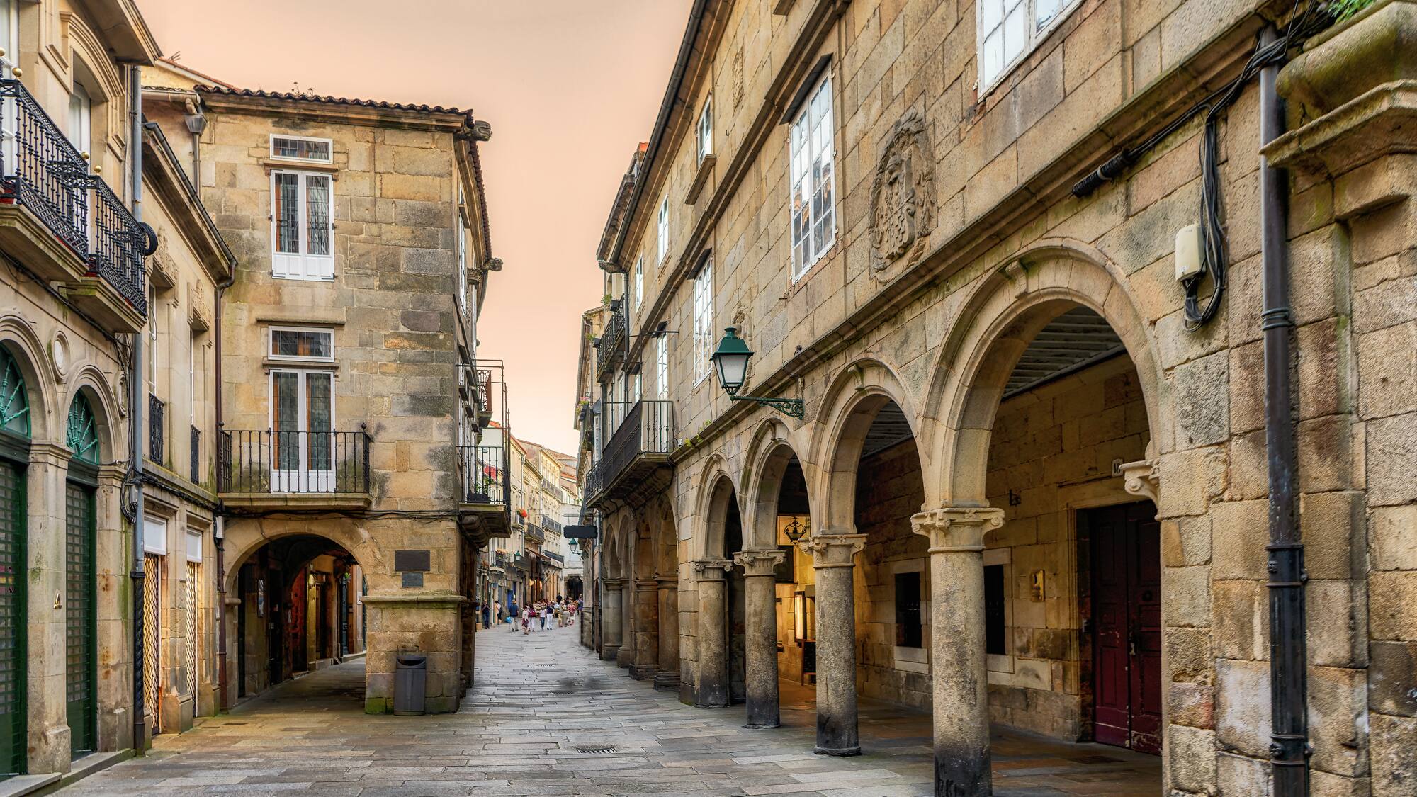 a stone building with arches and a walkway