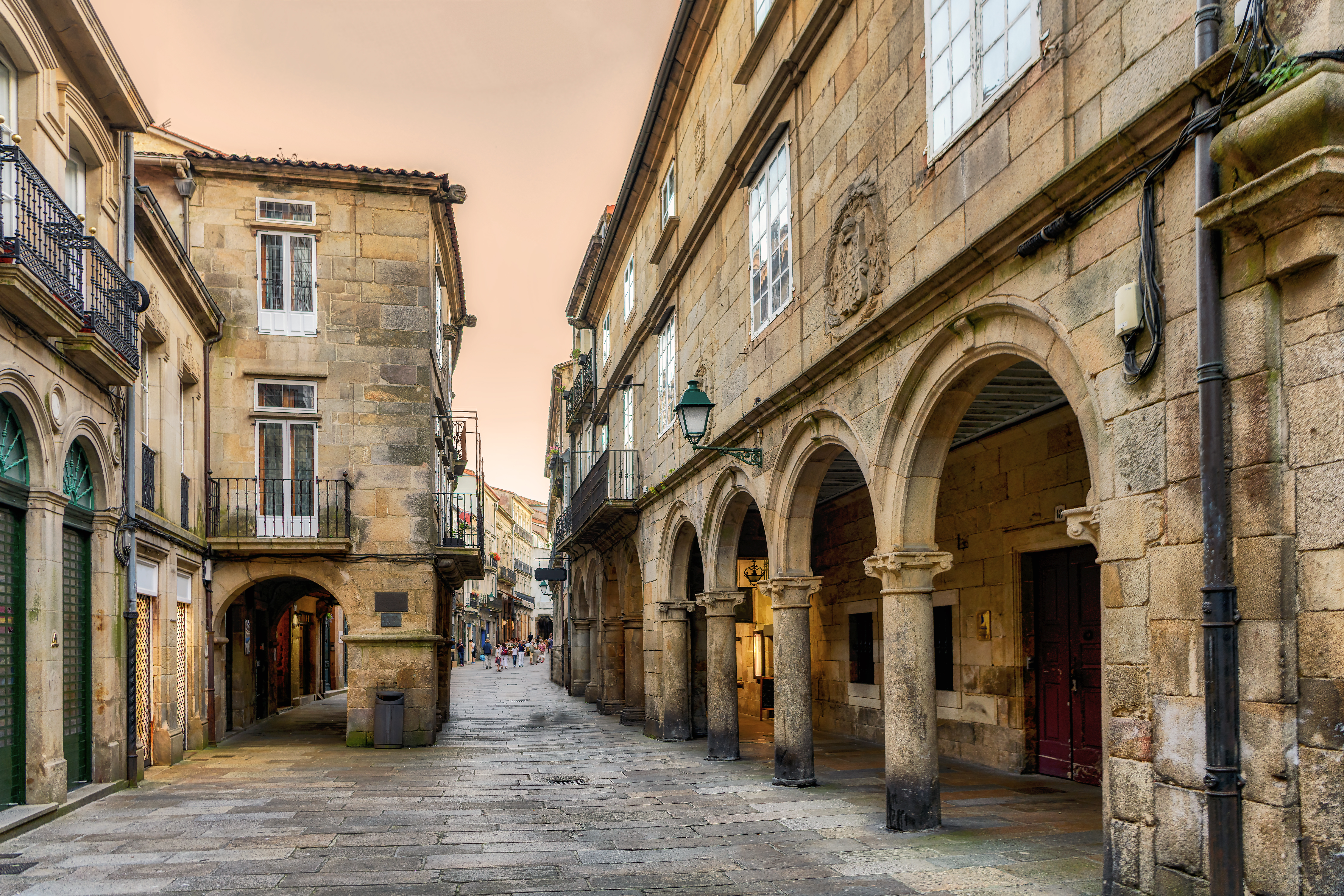 a stone building with arches and a walkway