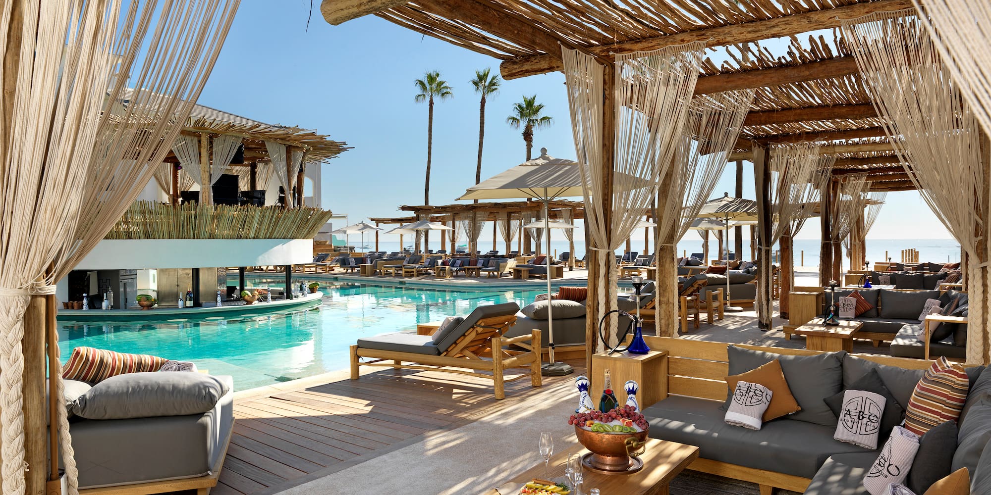 a pool with a lounge area and a lounge chair