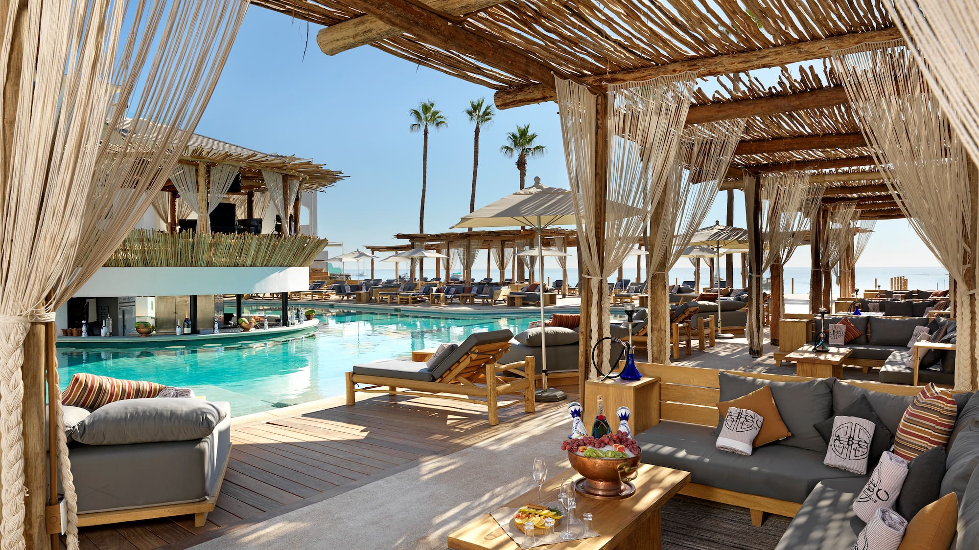 a pool with a lounge area and a lounge chair