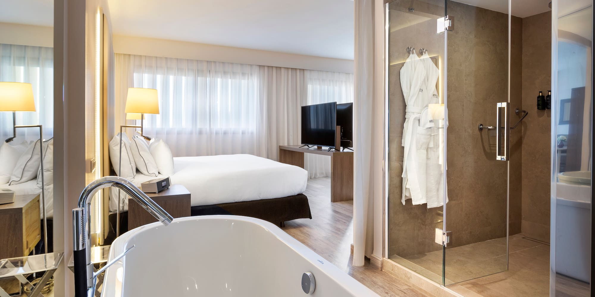 a bathroom with a bathtub and a glass shower