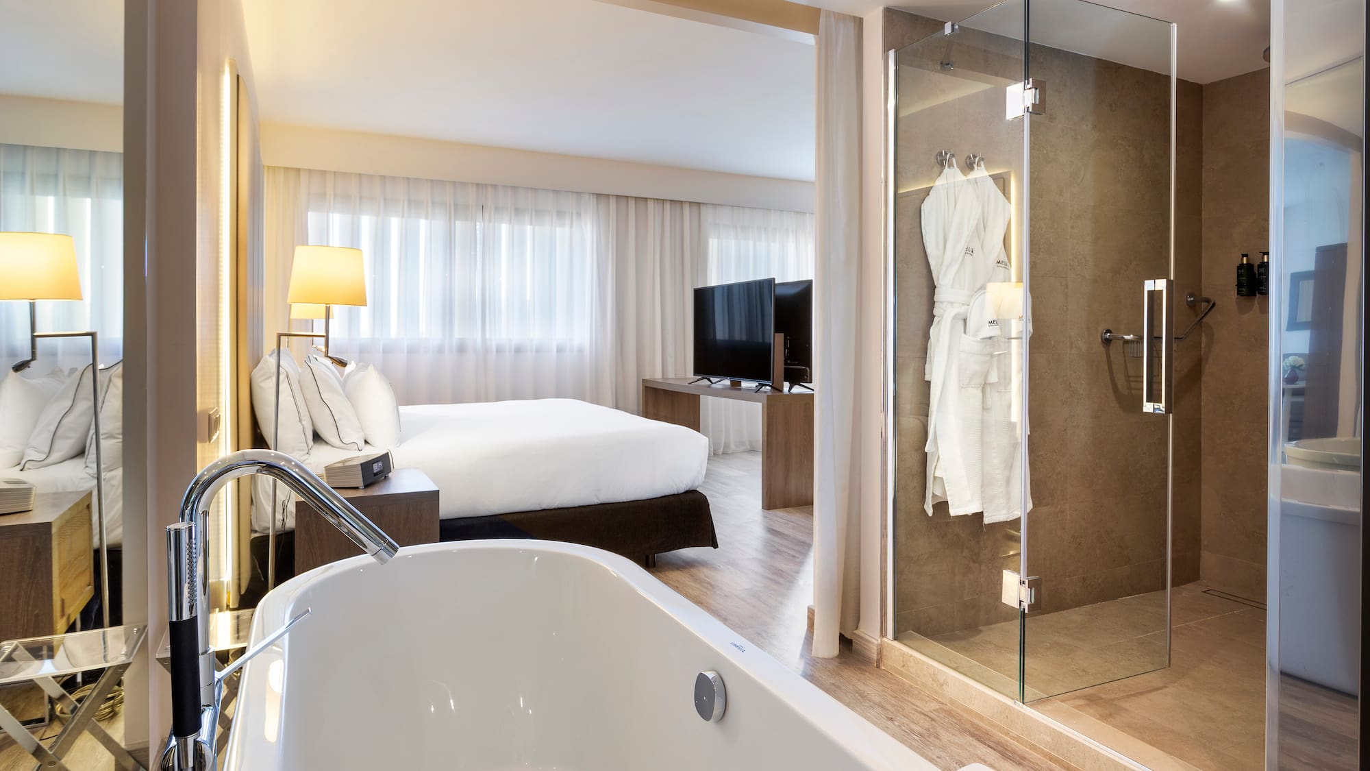 a bathroom with a bathtub and a glass shower