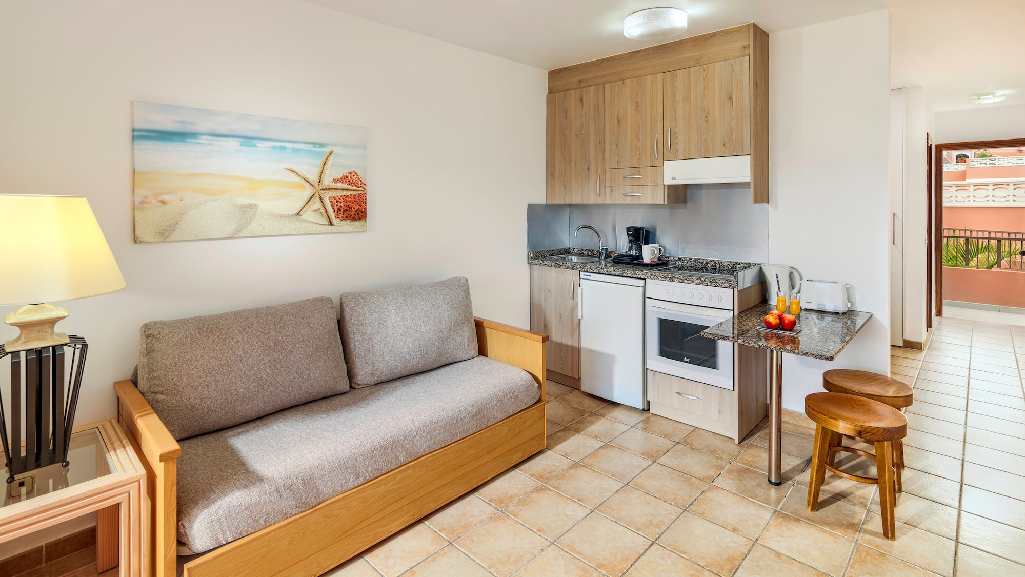 a room with a couch and kitchen