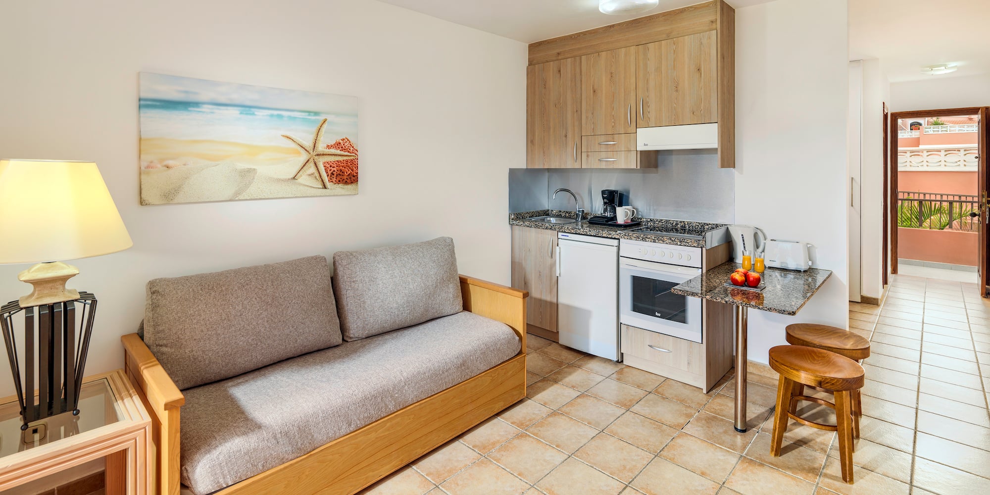 a room with a couch and kitchen