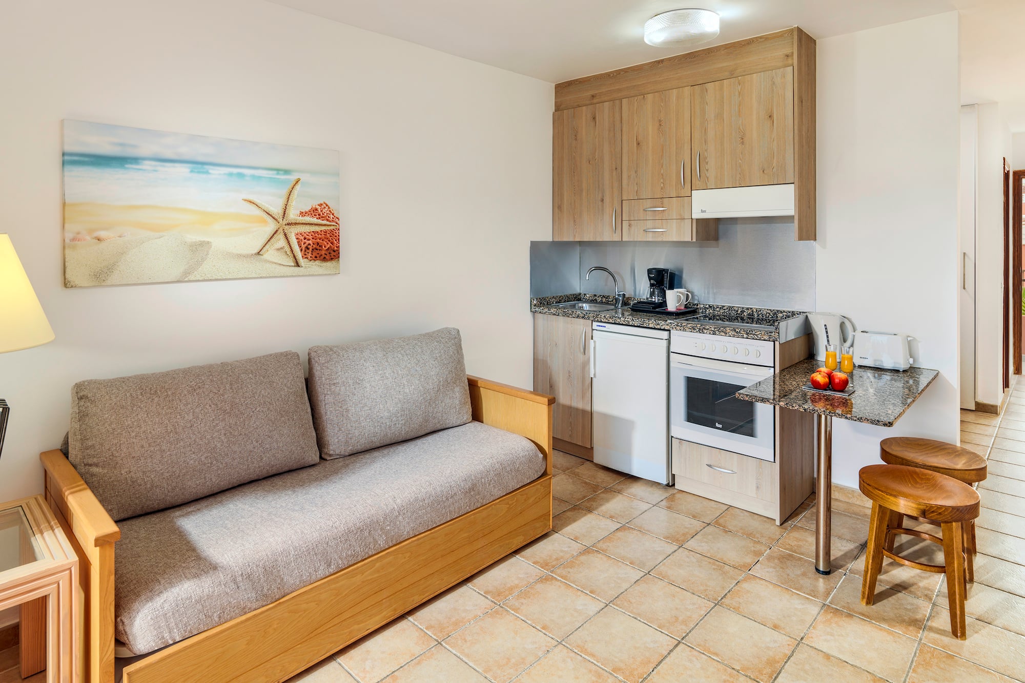 a room with a couch and kitchen