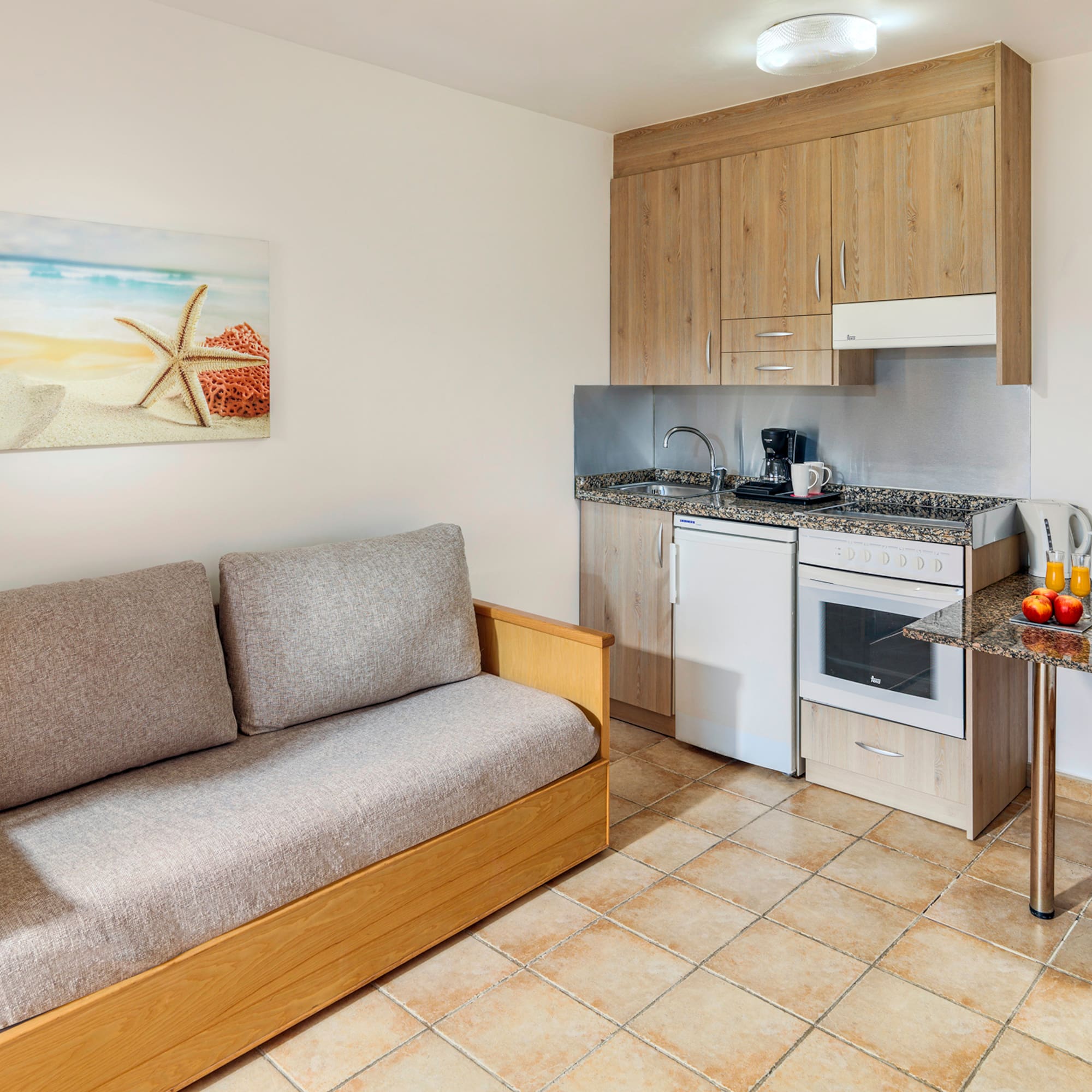 a room with a couch and kitchen