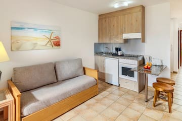 a room with a couch and kitchen