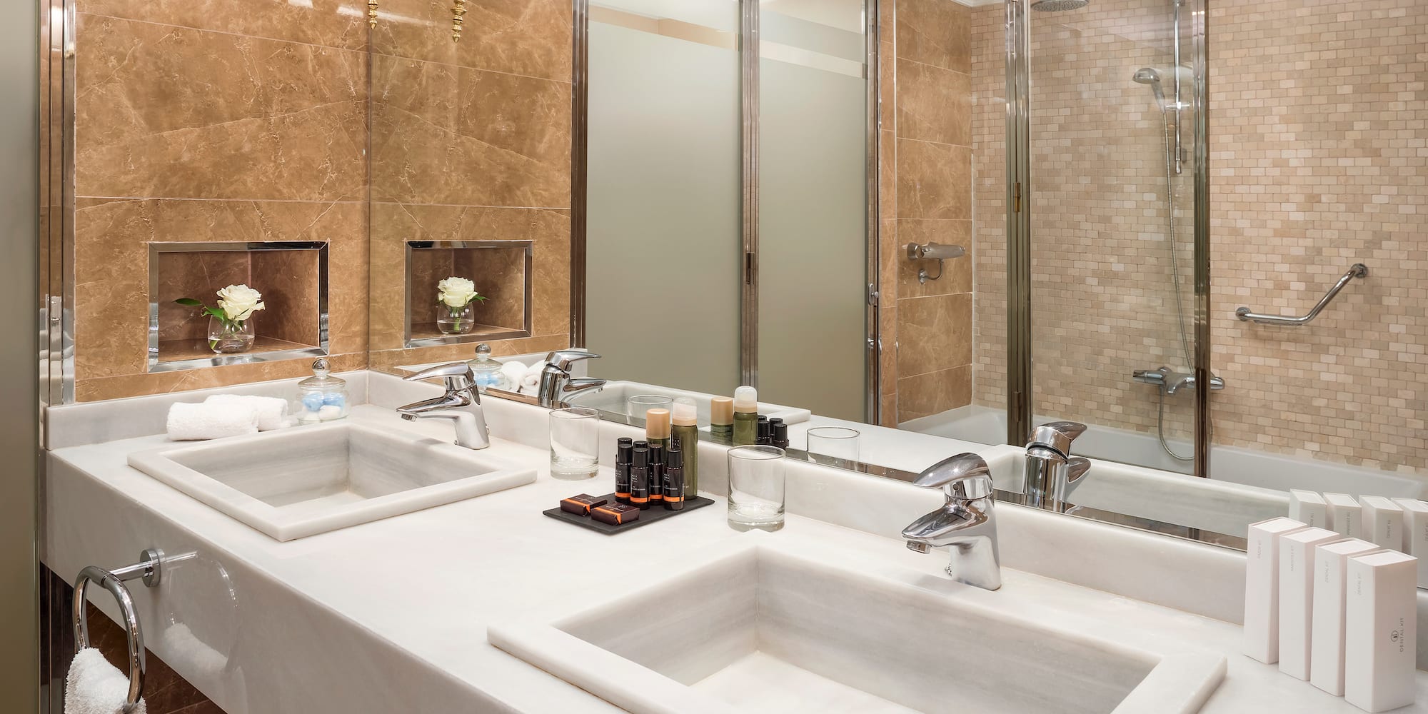 a bathroom with marble counter tops and sinks