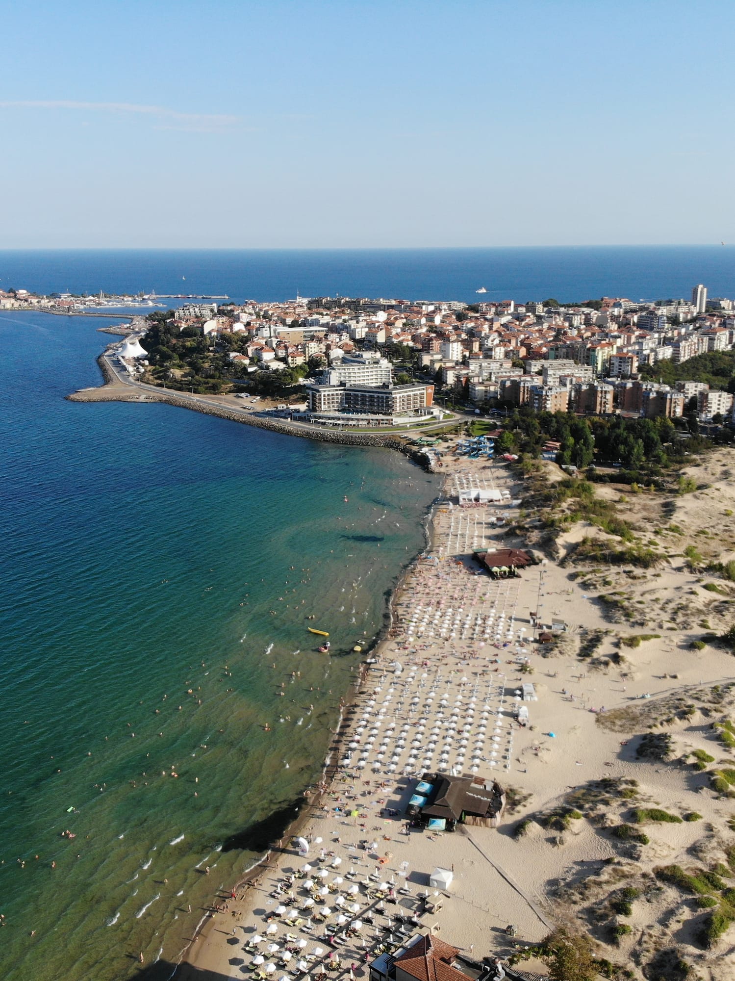 a beach with buildings and water