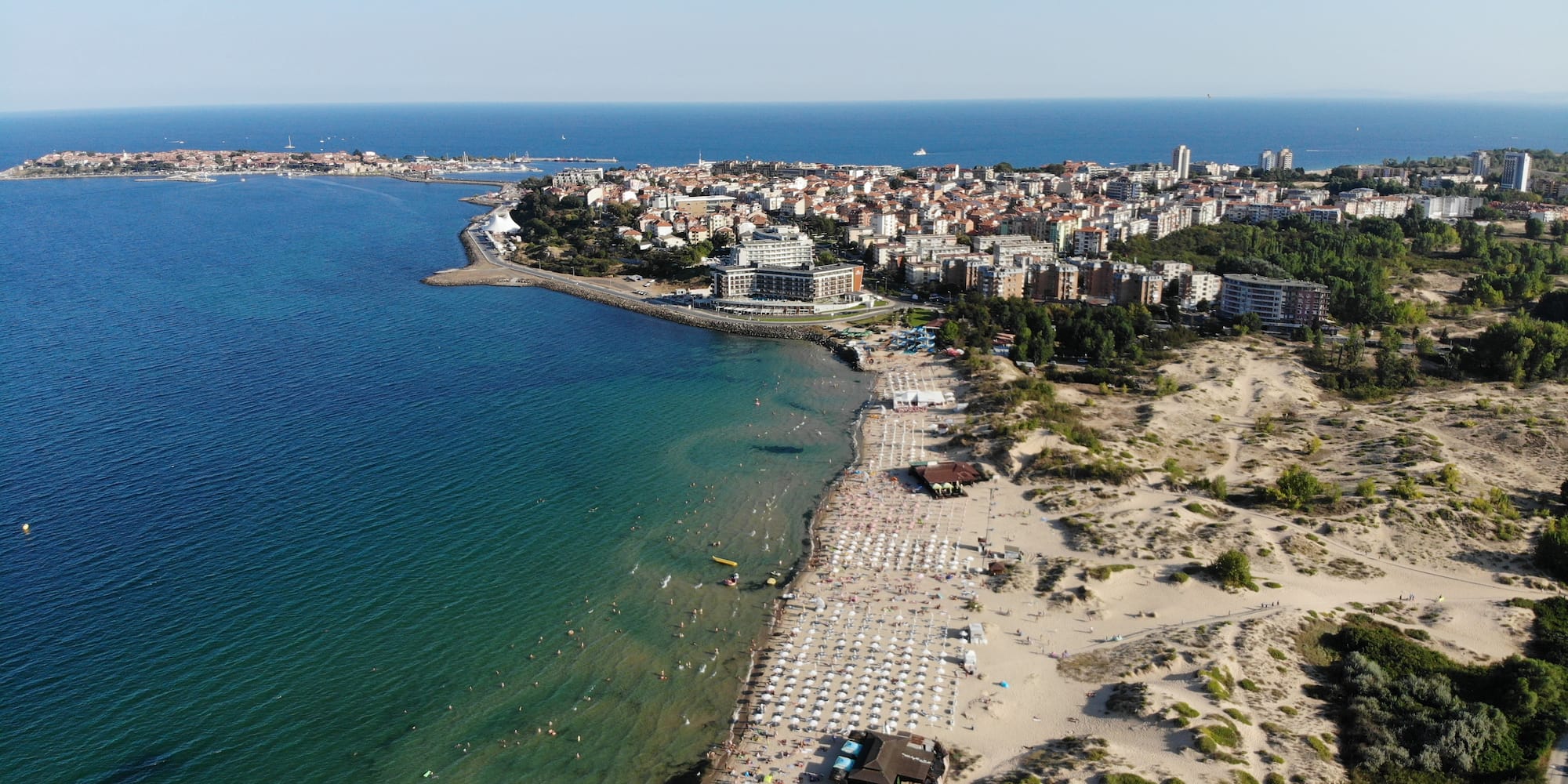 a beach with buildings and water