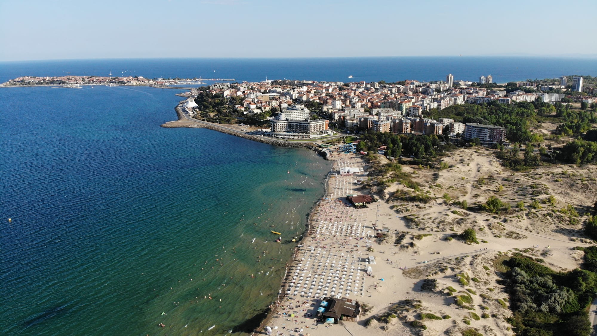 a beach with buildings and water