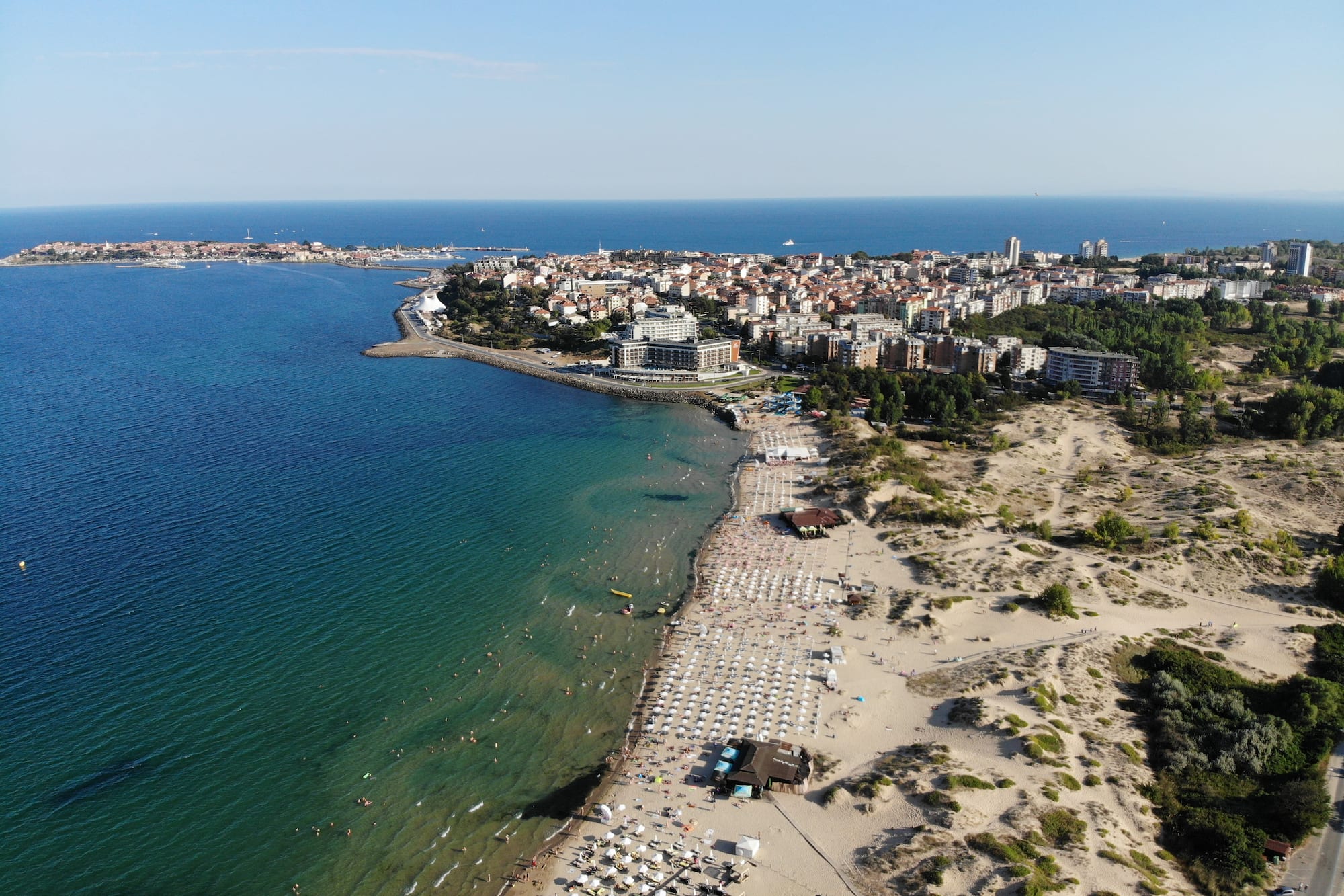 a beach with buildings and water