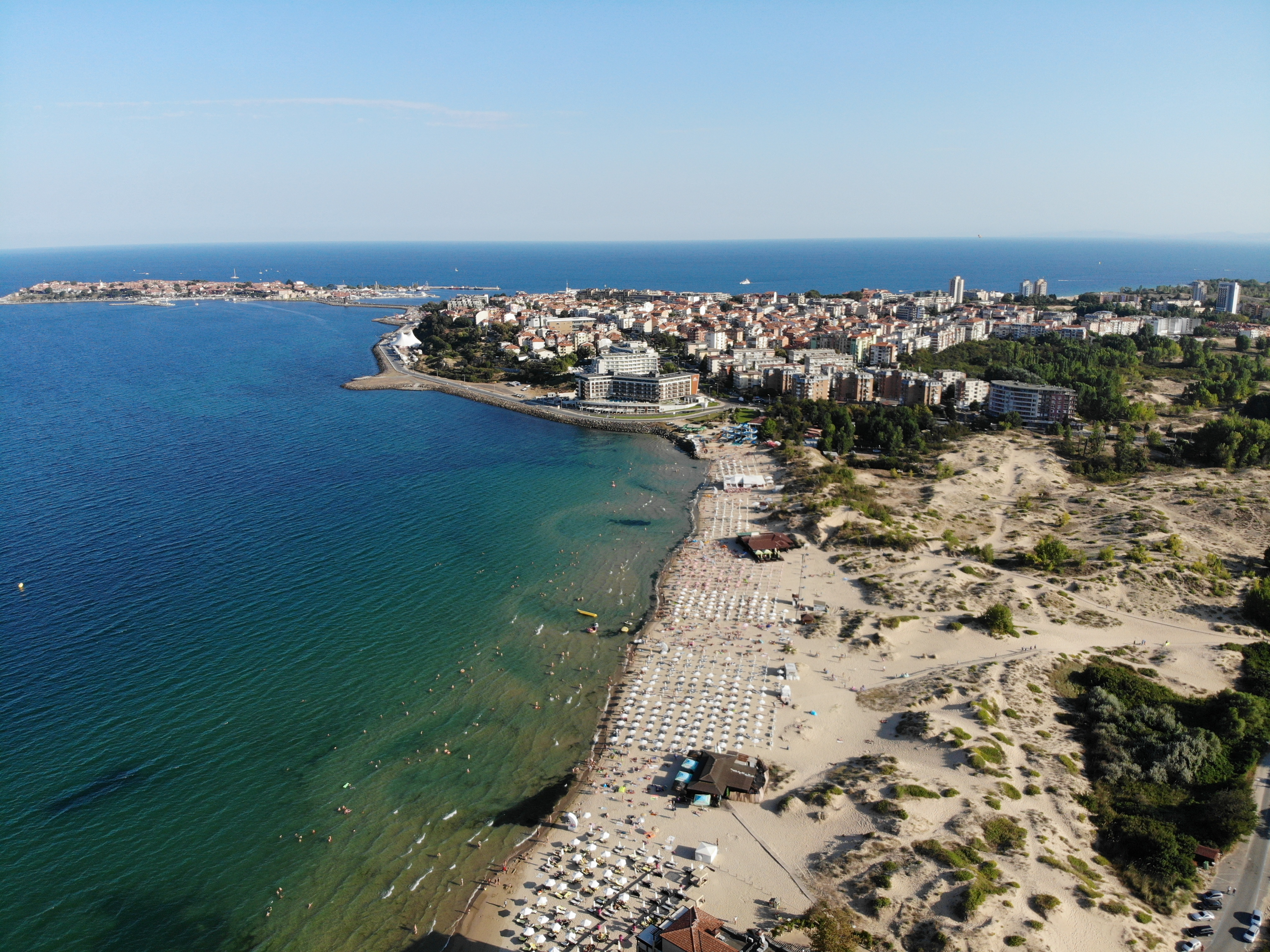 a beach with buildings and water