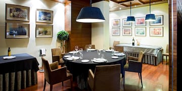 a room with a round table and chairs