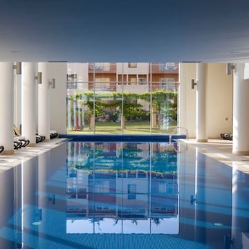 a indoor swimming pool with a large glass door