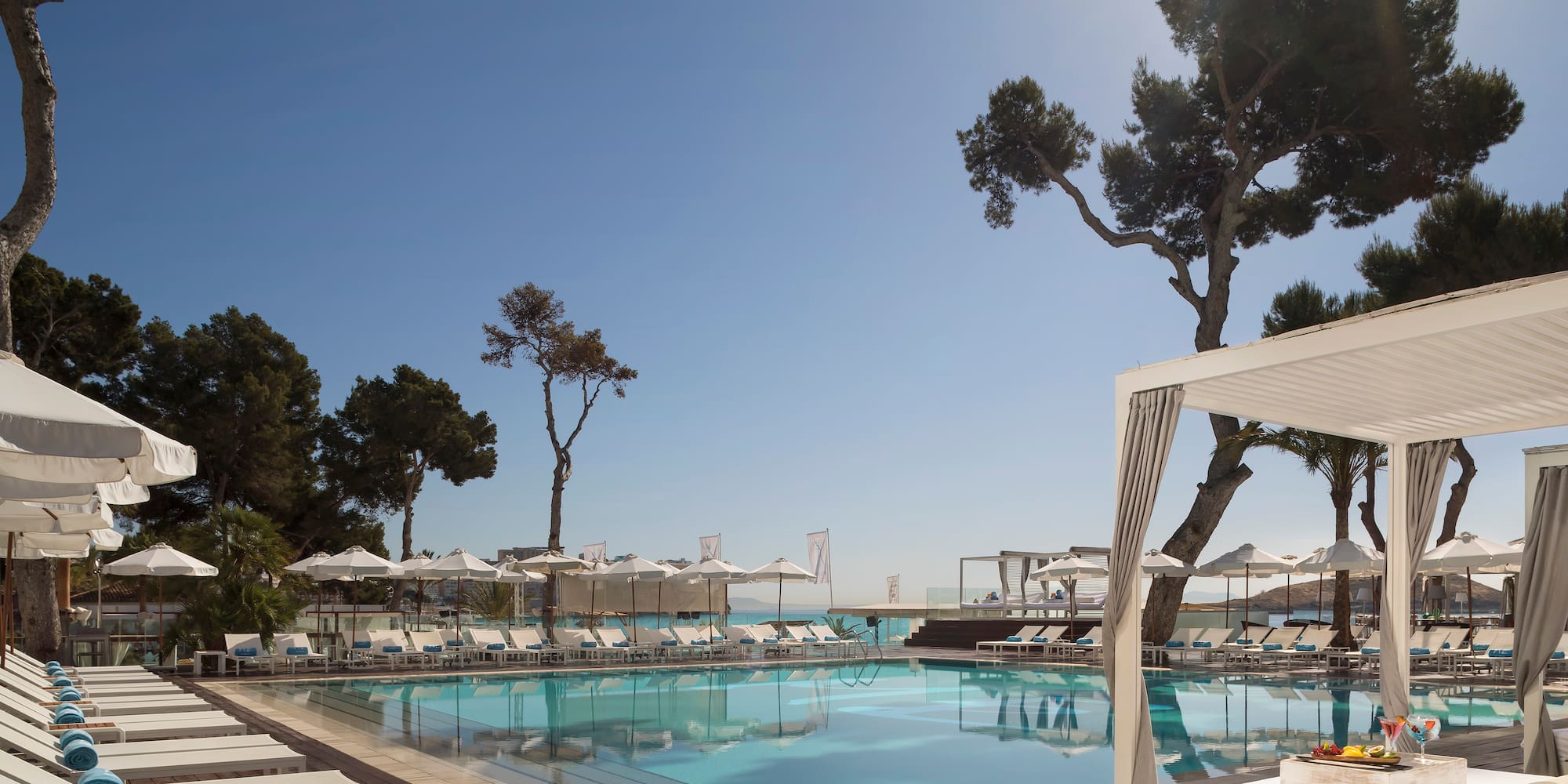 a pool with umbrellas and chairs
