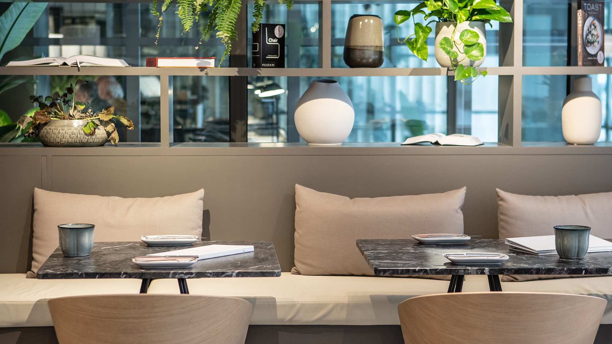 a table and chairs in a room with plants