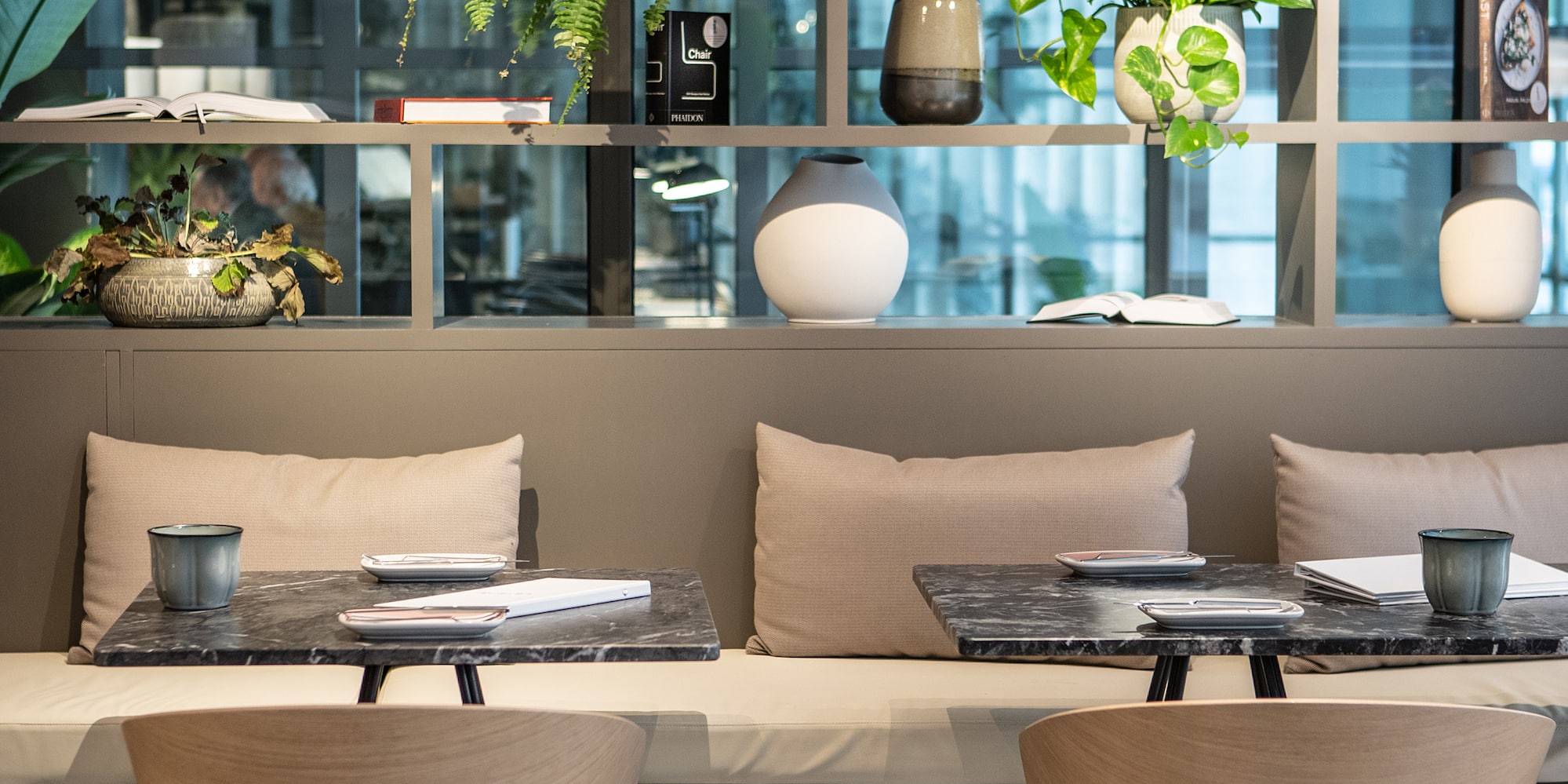 a table and chairs in a room with plants