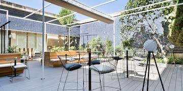 a patio with chairs and tables