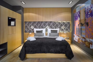 a bed with a black bedding and a black and white wall