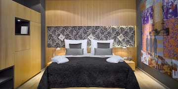 a bed with a black bedding and a black and white wall