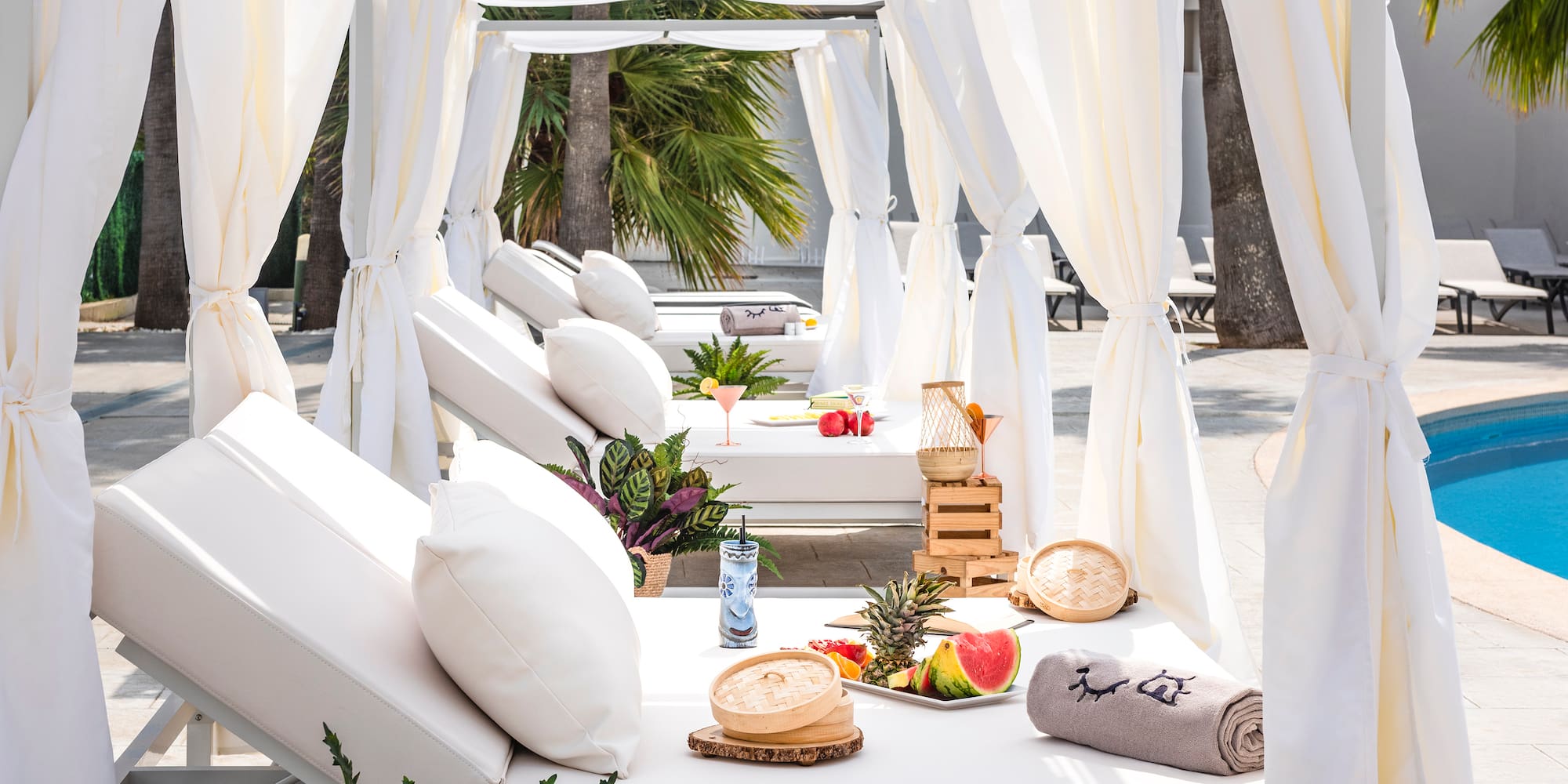 a white canopy with white pillows and food on it
