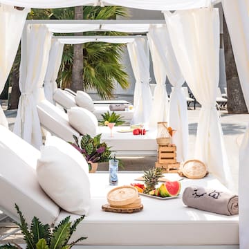 a white canopy with white pillows and food on it