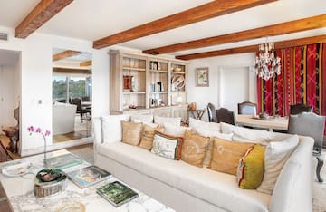 a living room with a couch and a mirror