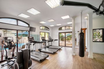 a gym with treadmills and punching bag