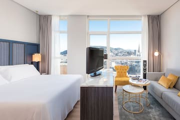 a room with a bed and a television
