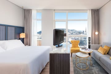 a room with a bed and a television