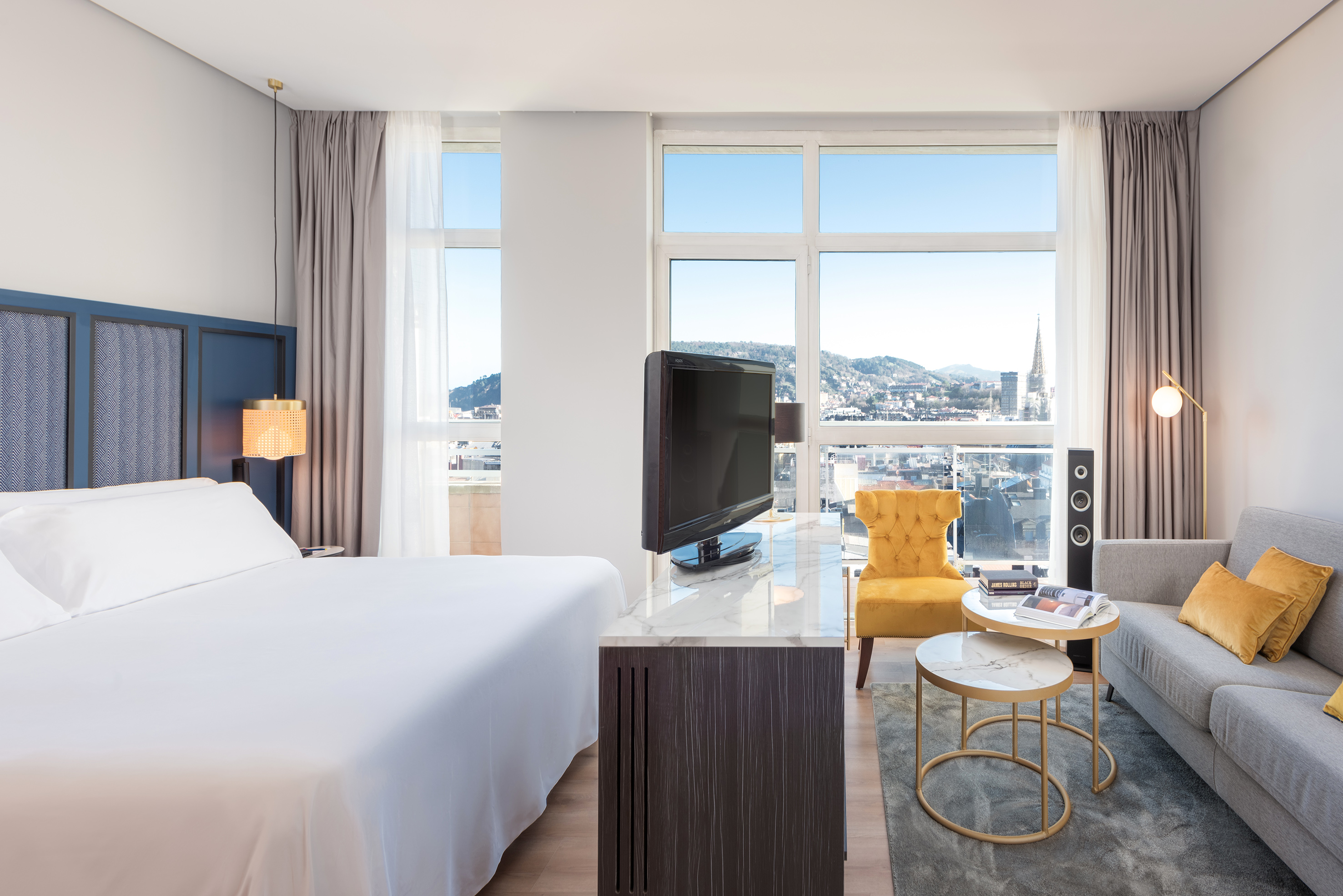 a room with a bed and a television