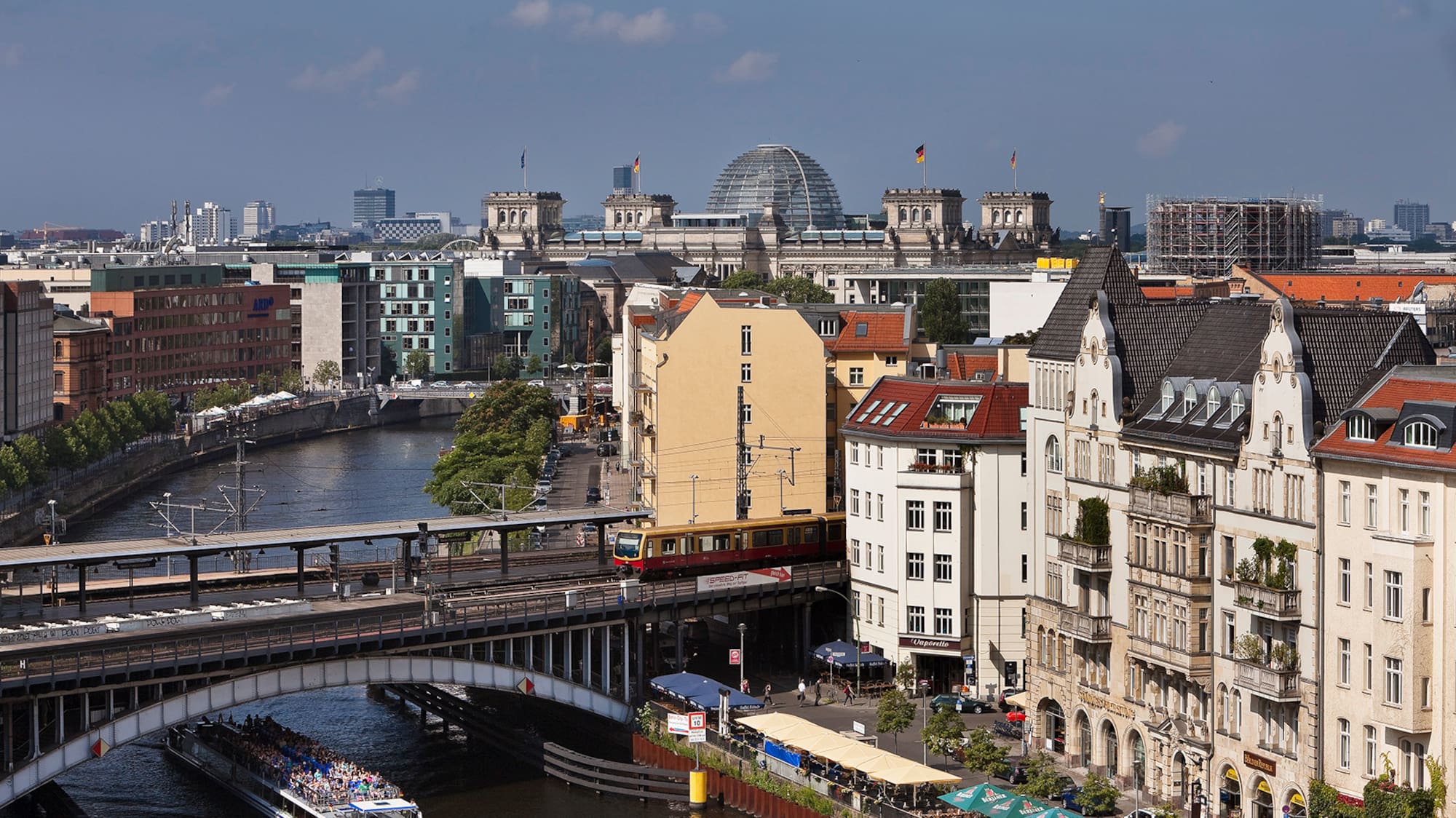a bridge over a river with buildings and a boat
