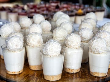 a group of desserts in plastic cups