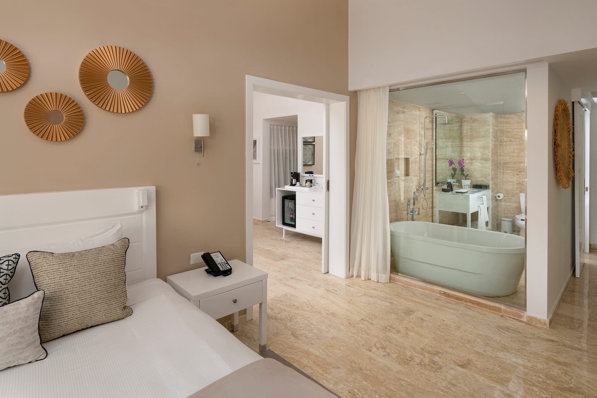 a bedroom with a bathtub and a bed