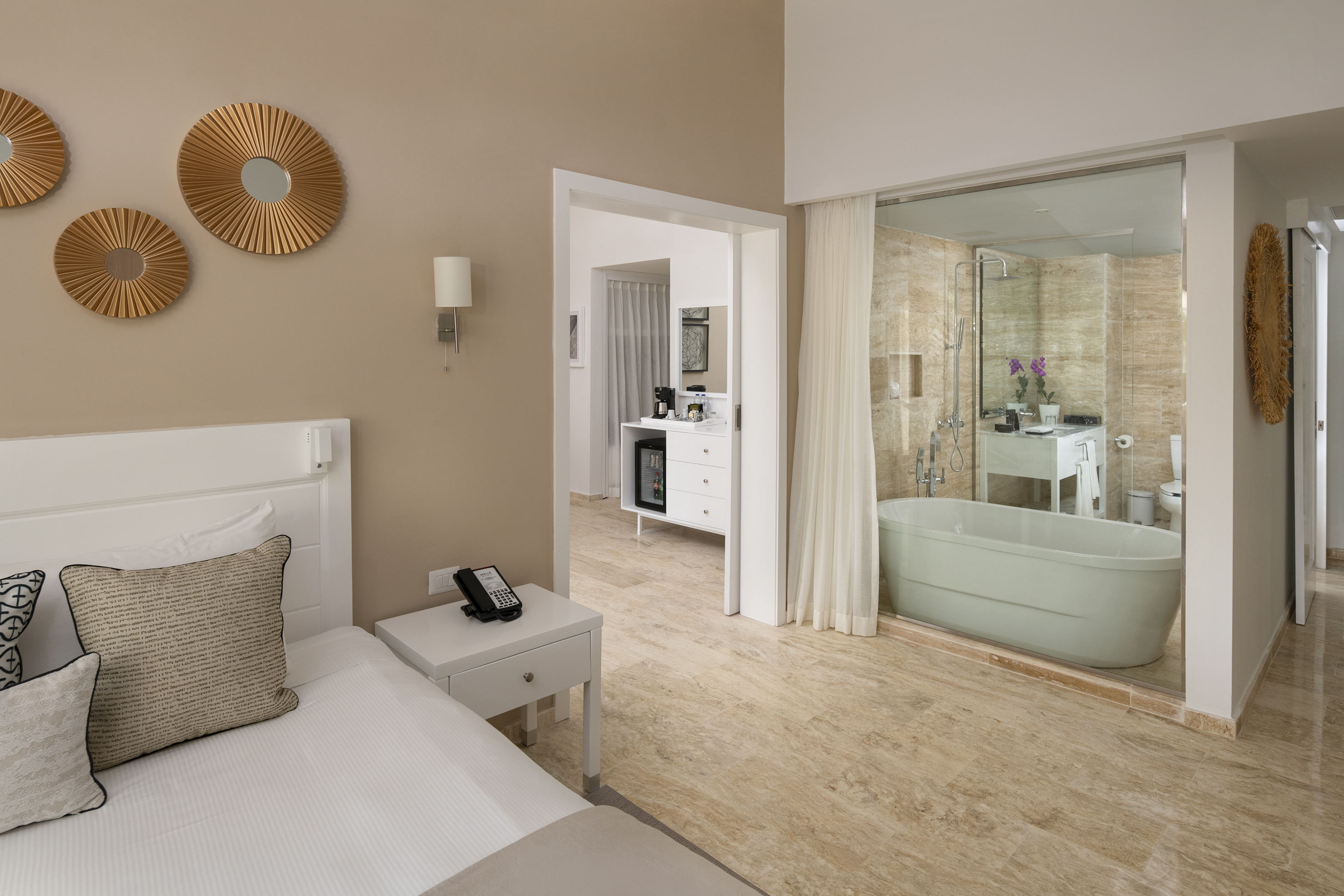 a bedroom with a bathtub and a bed