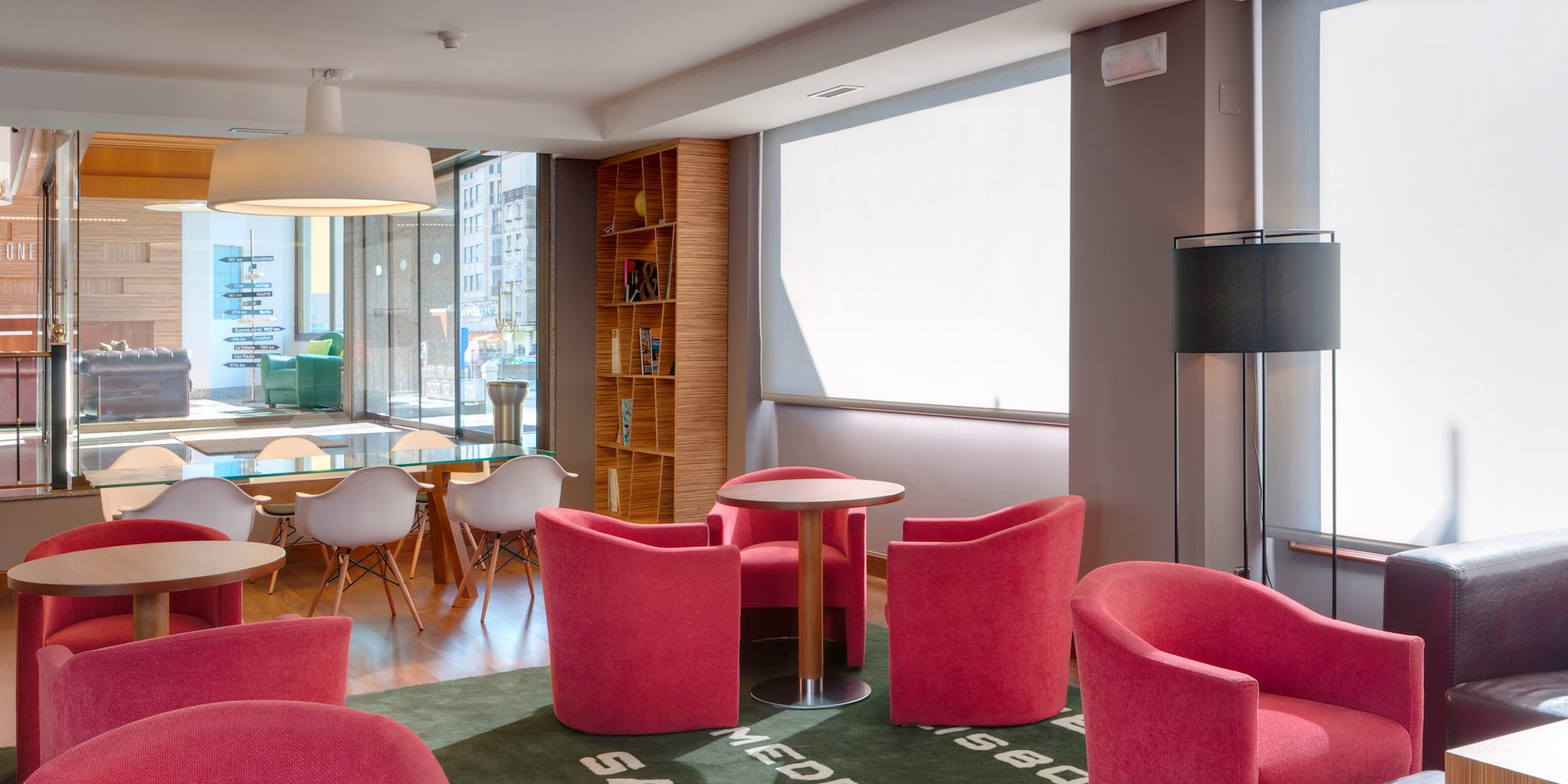 a room with red chairs and a table