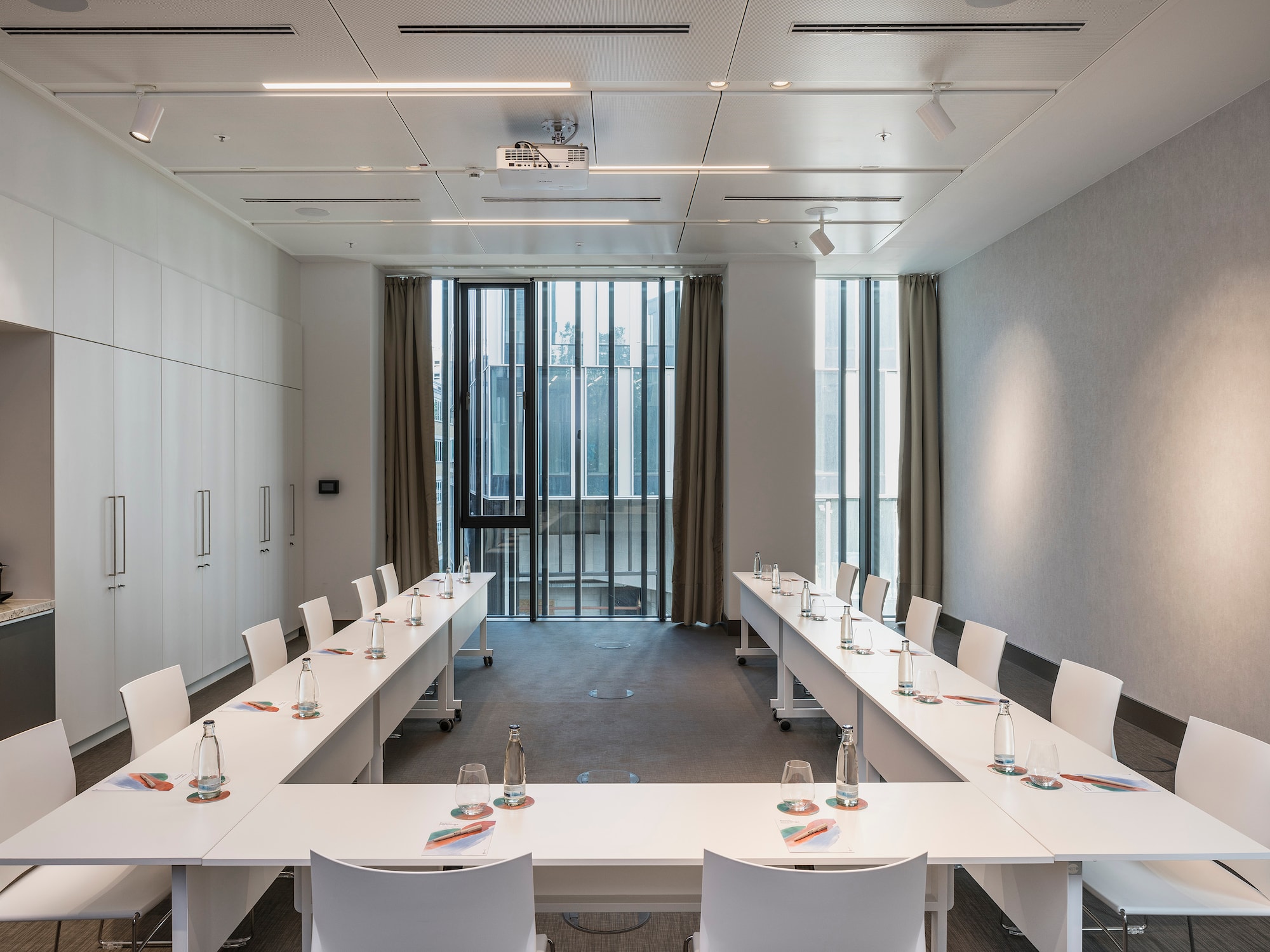 a room with white tables and chairs