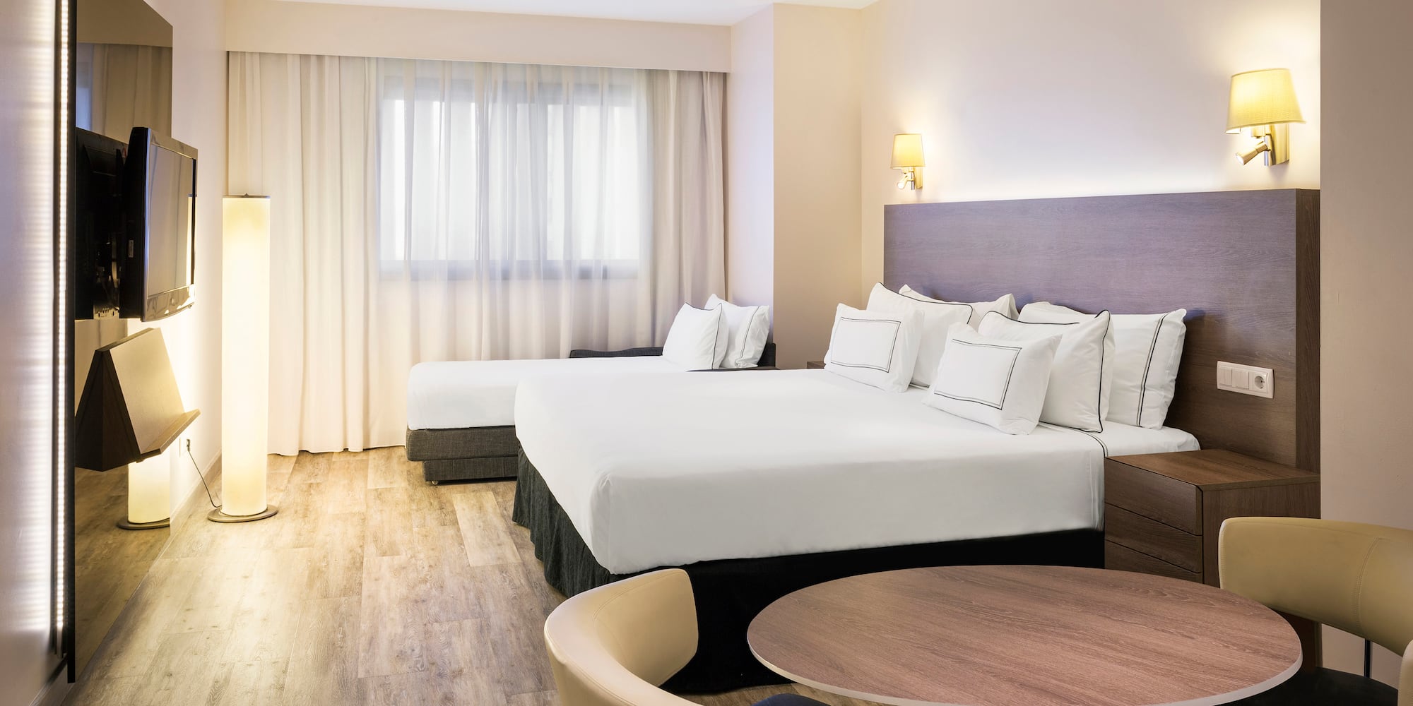 a room with two beds and a table