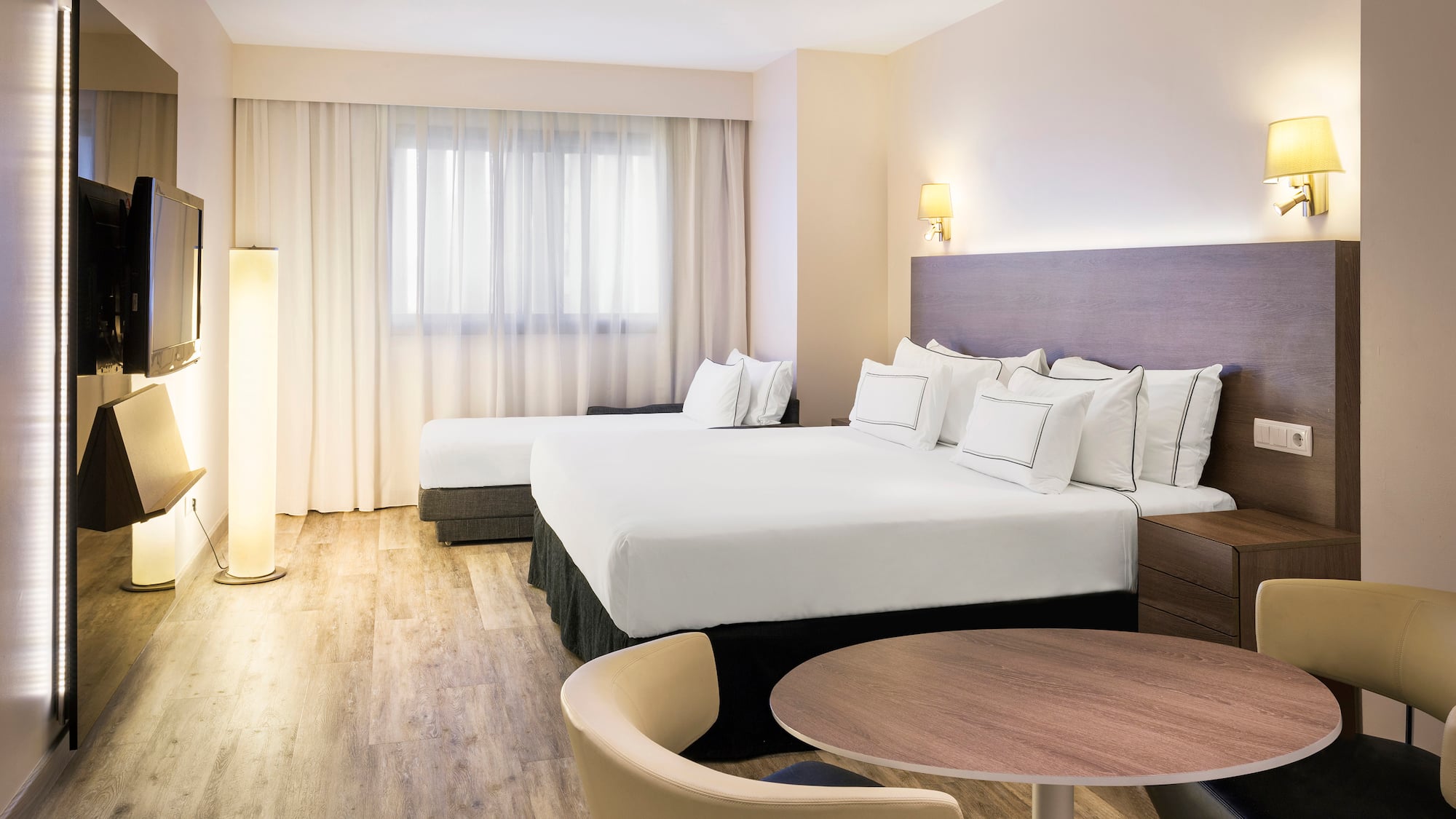 a room with two beds and a table