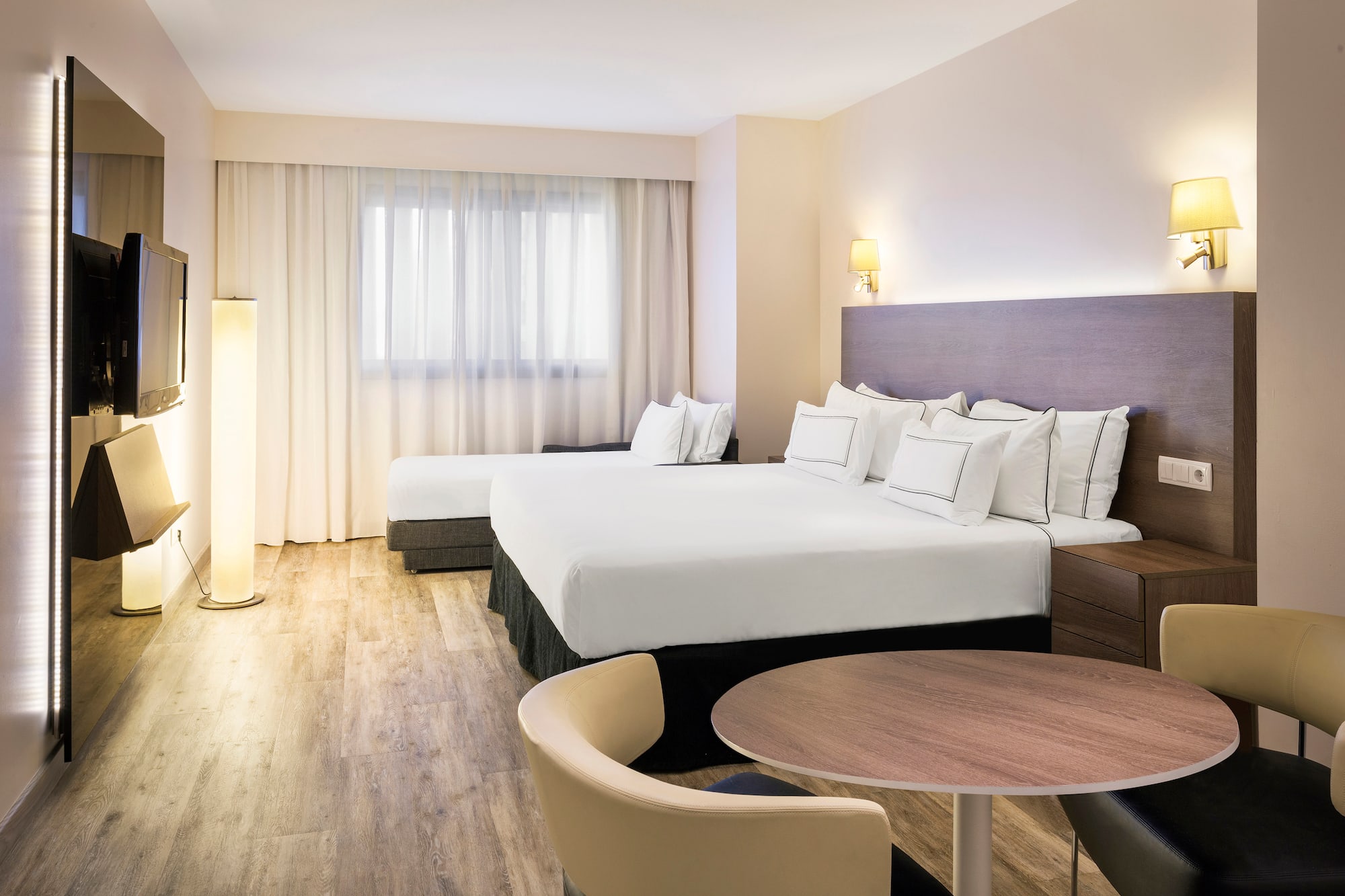 a room with two beds and a table