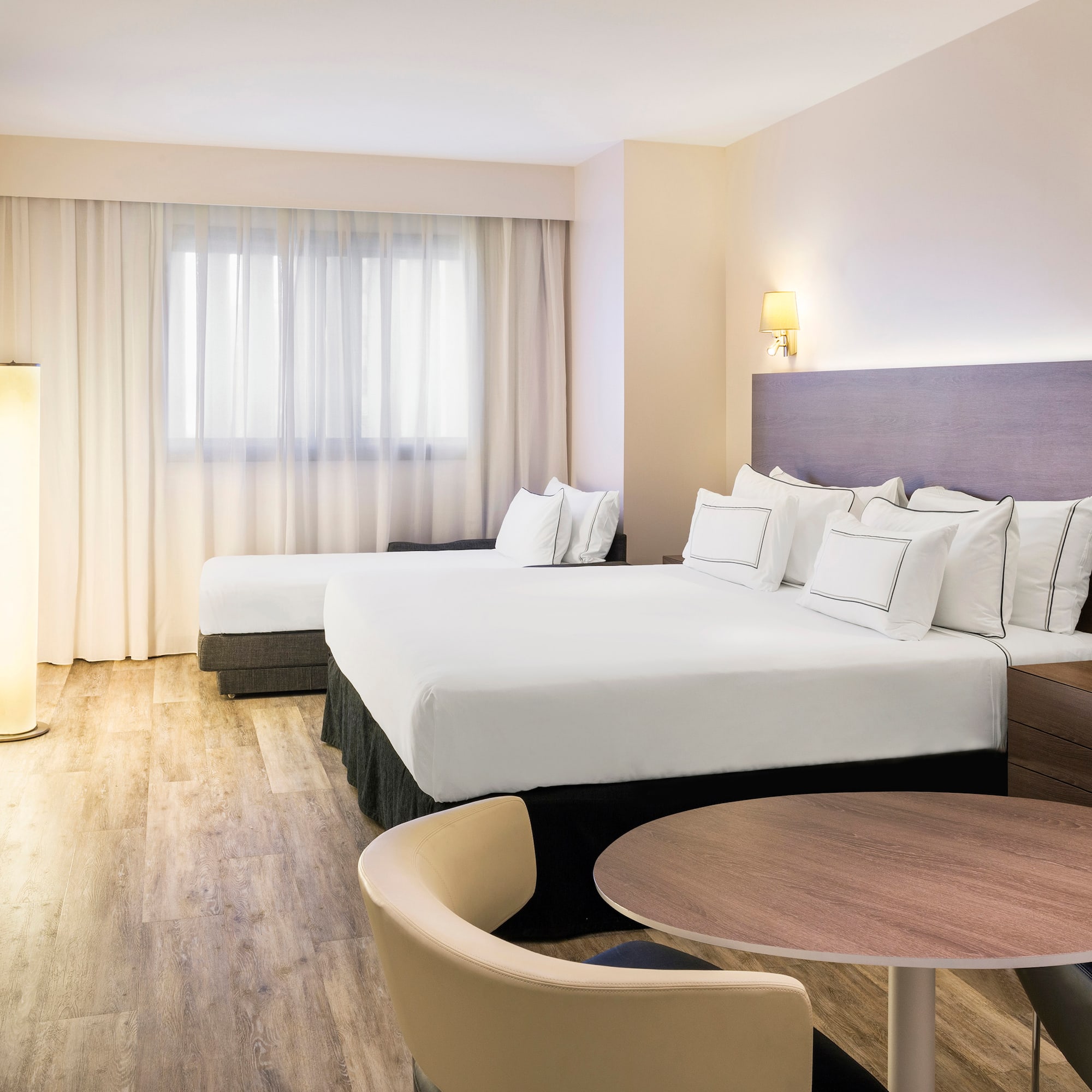 a room with two beds and a table